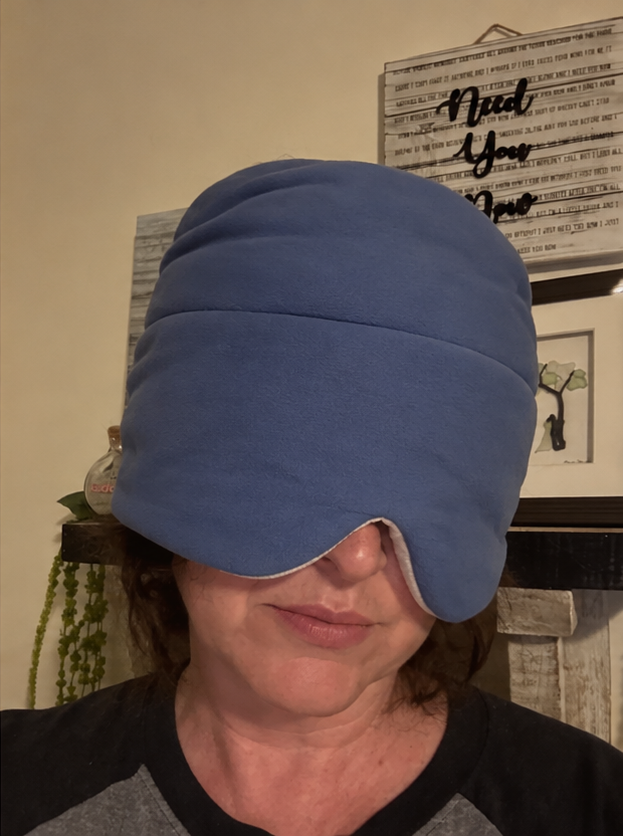 Person wearing the blue weighted sleep hood indoors