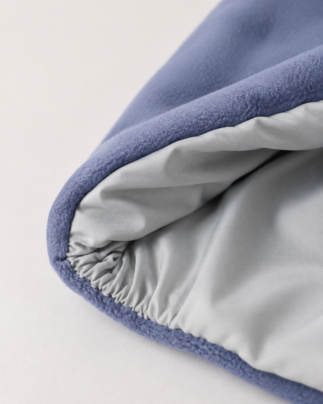 Concept close-up of blue plush fabric meeting a smooth grey lining