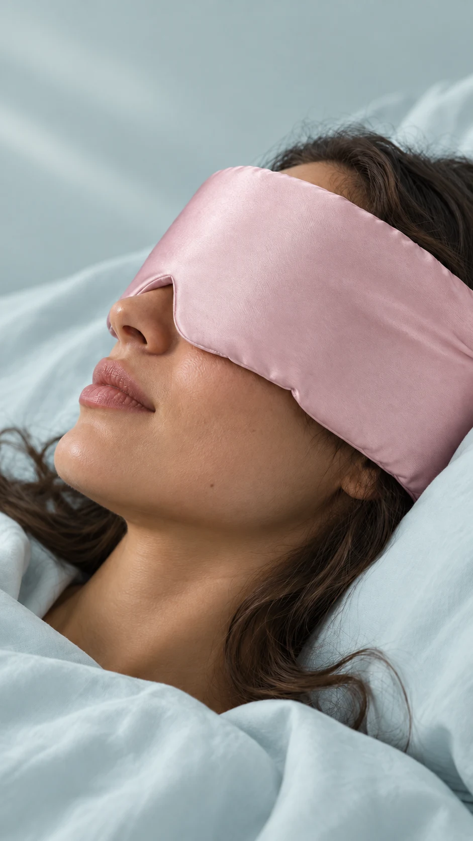 Side-profile close-up showing the pink sleep mask against skin